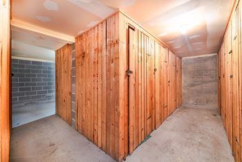A room under construction with wooden walls and a concrete floor.