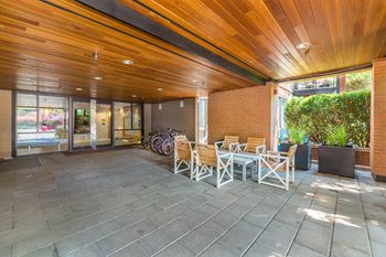 A patio with a table and chairs and a bicycle.