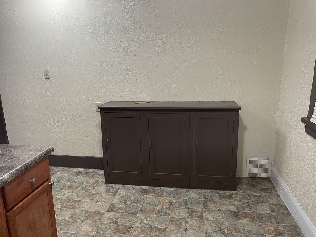 an empty room with a cabinet in the corner
