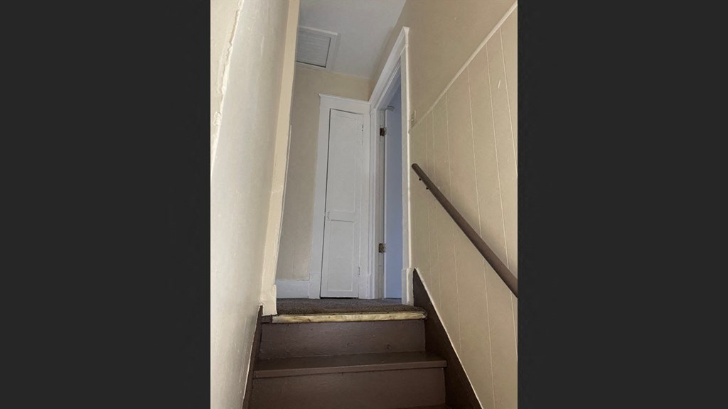 the door is open to a stairwell with a door