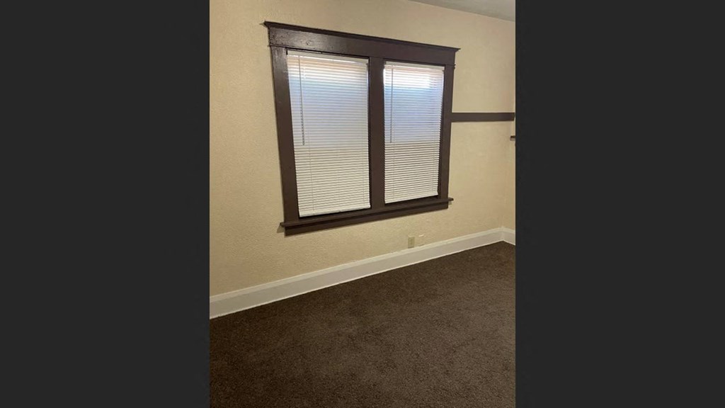 a room with a window and a carpet