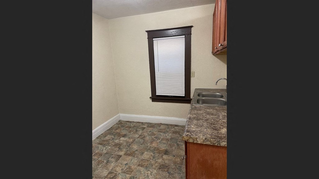 a kitchen with a sink and a window