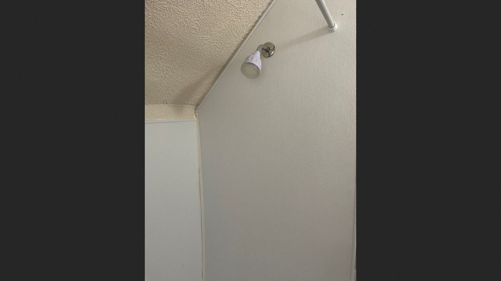 a surveillance camera on the ceiling of a room
