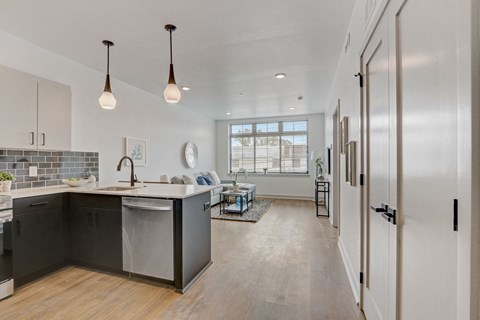 an open kitchen and living room with a pass through to a living room