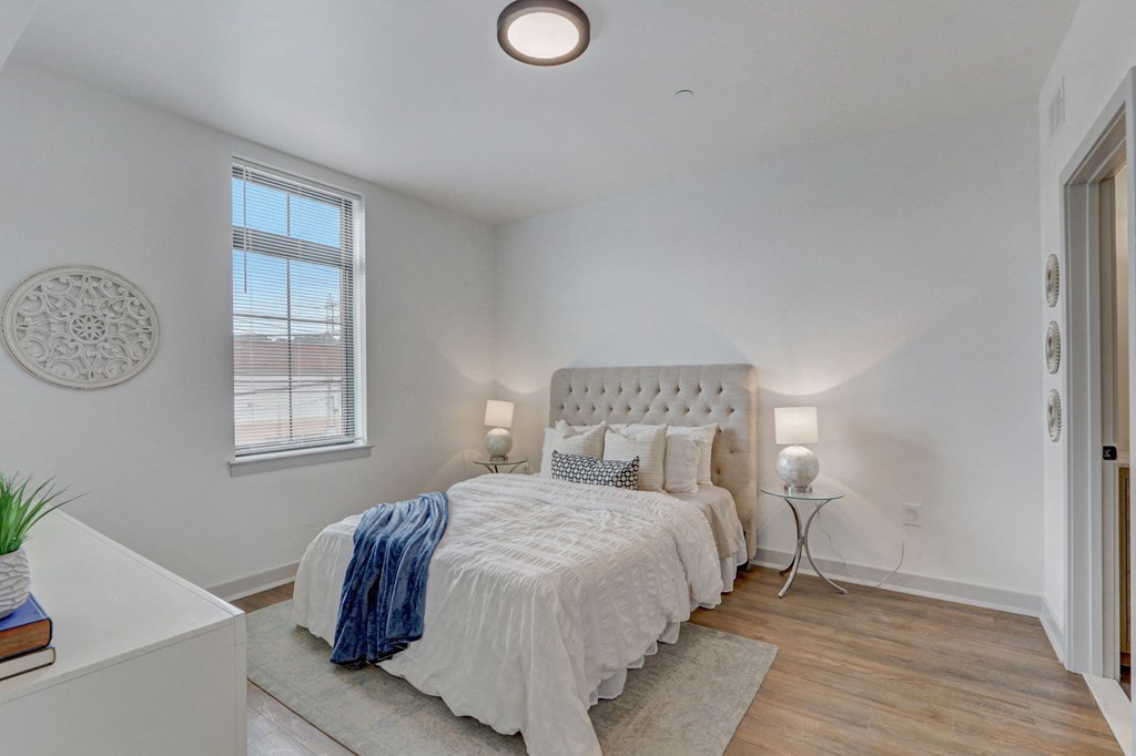 a bedroom with a bed and a window