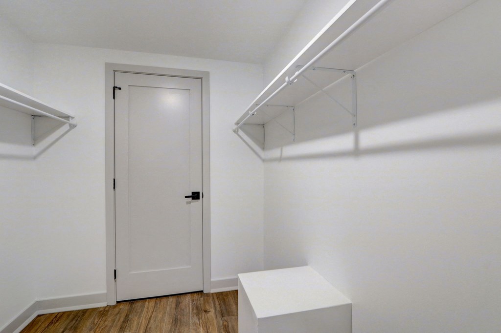an empty room with white walls and a white door