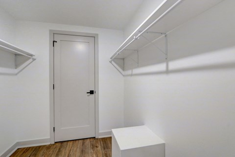 an empty room with white walls and a white door