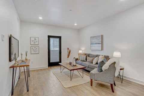 an open living room with a couch and a chair