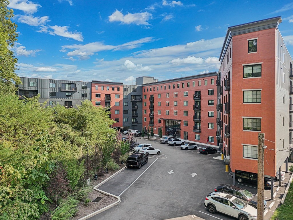A parking lot with cars and buildings in the background.