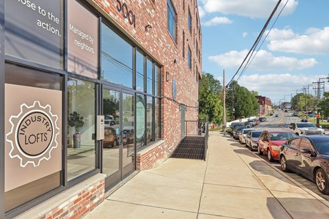 A brick building with a sign that says Industry Lofts.