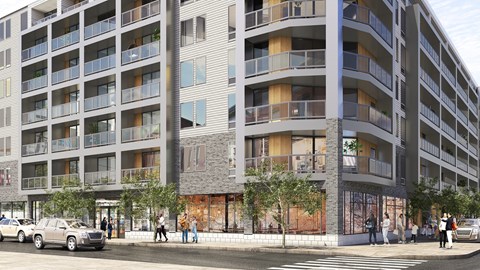 A modern apartment building with cars parked in front and people walking on the sidewalk.
