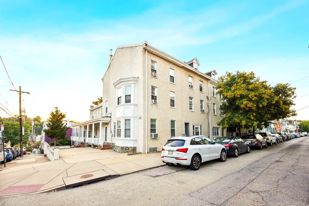 an apartment building on a city street with parked cars
