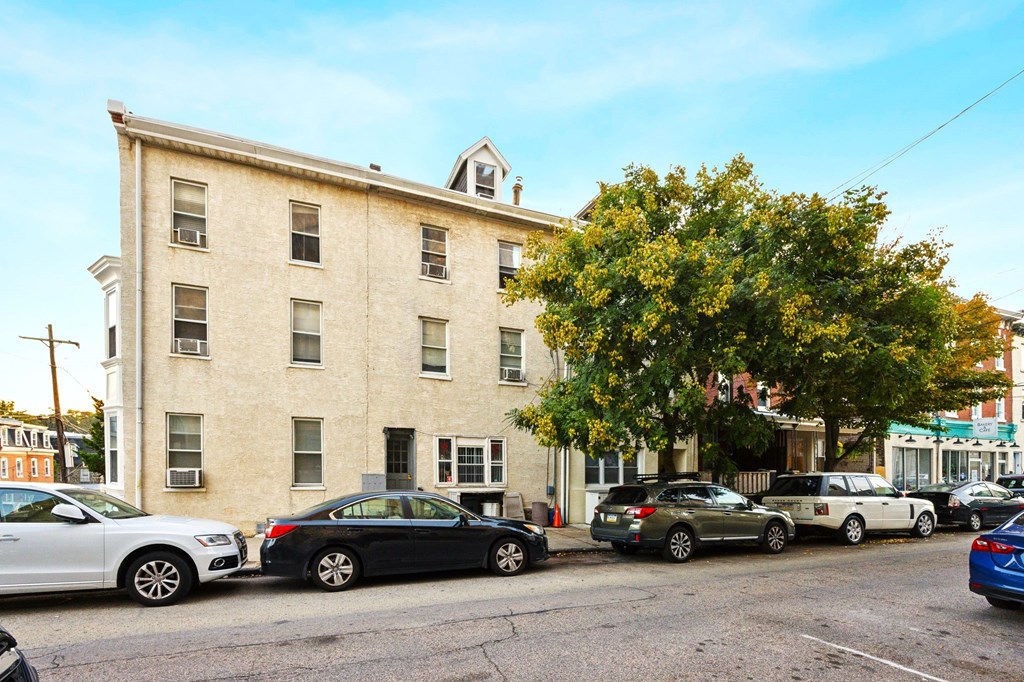 a large brick building with cars parked in front of it