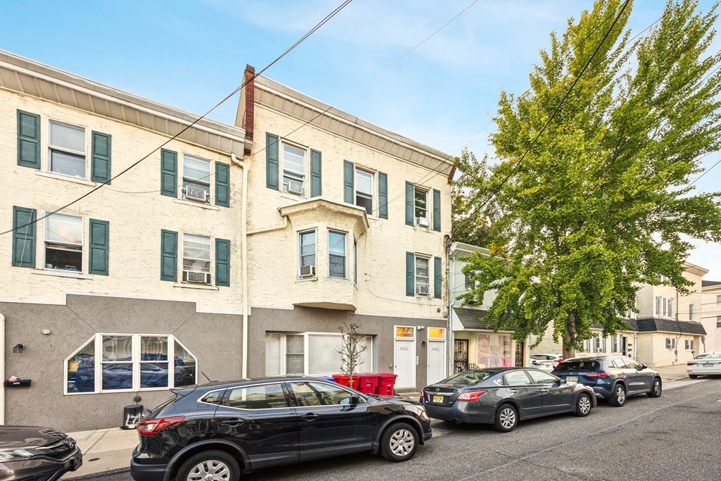 a white building with cars parked in front of it