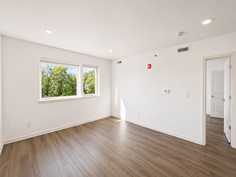 A room with a window and a door.