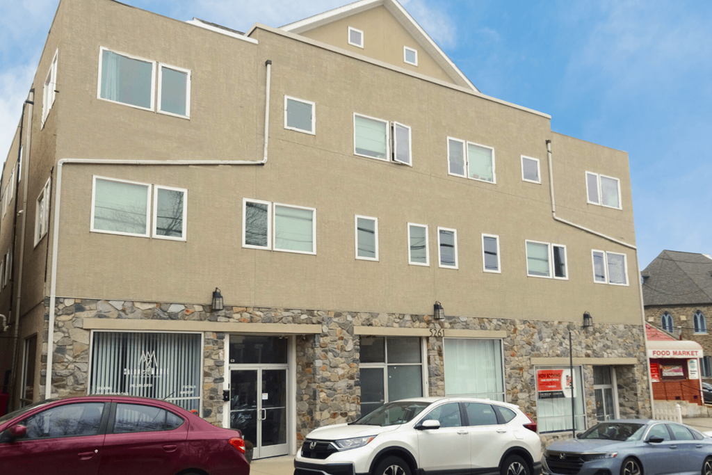 a large building with cars parked in front of it