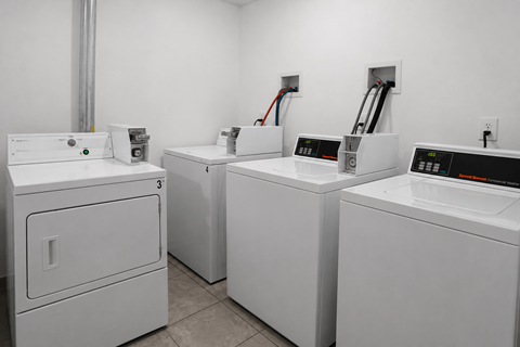 A row of washing machines in a laundromat.