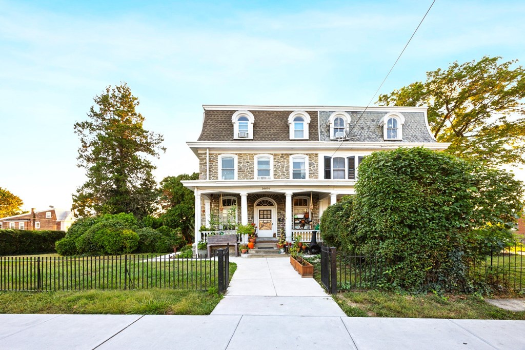a large house with a sidewalk in front of it