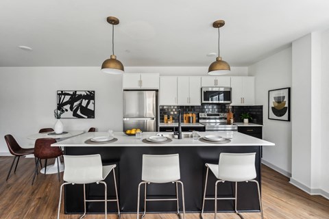 A modern kitchen with a dining table and chairs.