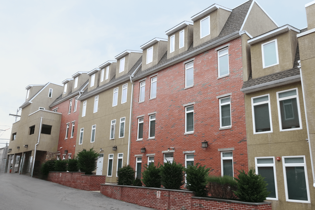 a row of brick apartment buildings on a street