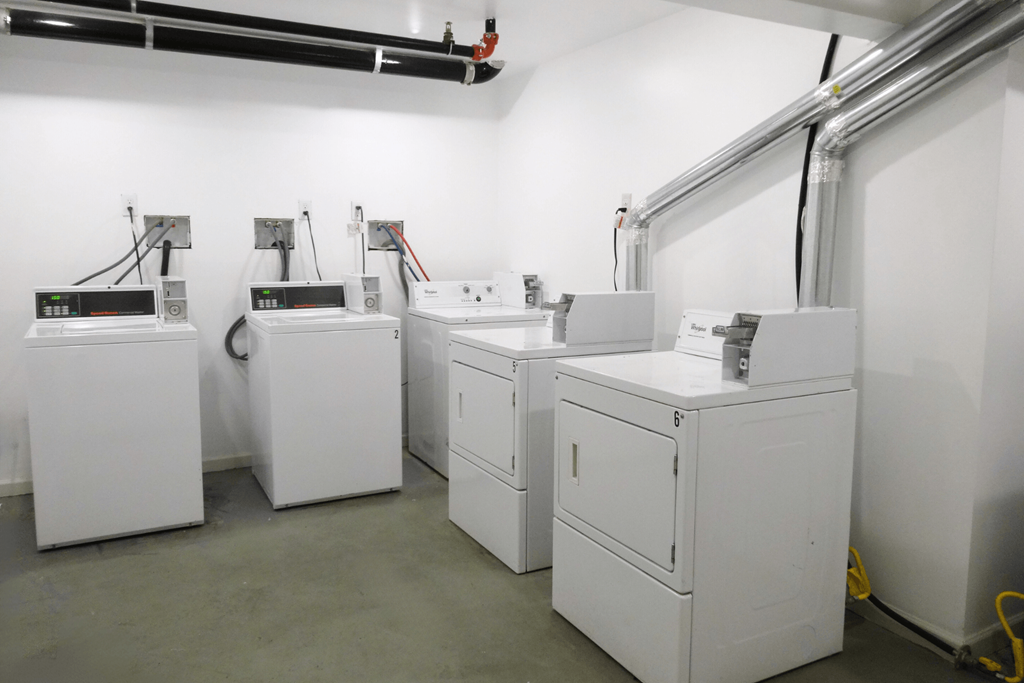 a row of washers and dryers in a room