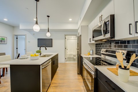 A modern kitchen with a black and white color scheme.