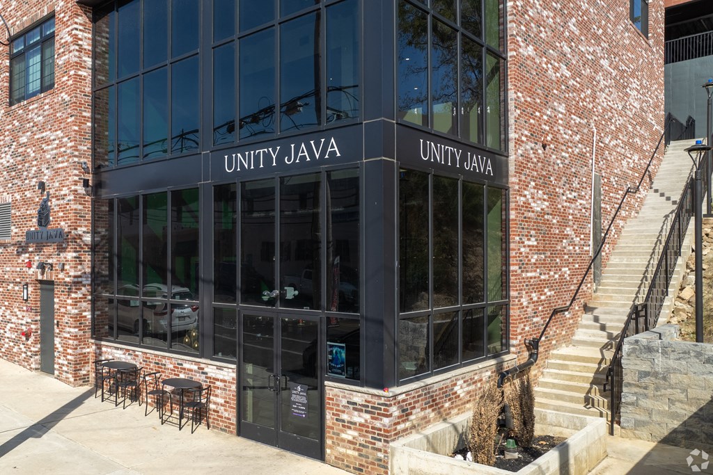 A building with a glass facade and a sign that reads "UNITY JAVA".