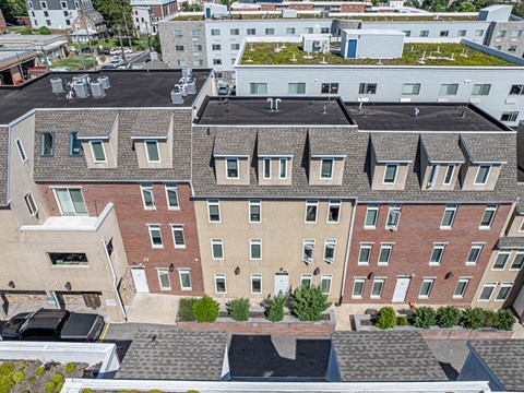 an aerial view of a building with a roof covered in plants