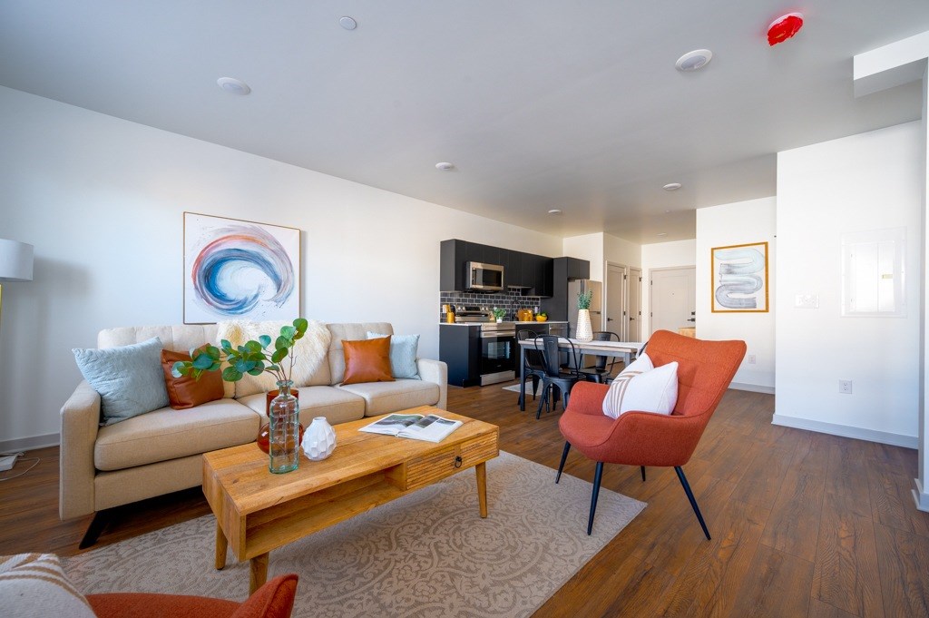 A living room with a couch, a chair, and a coffee table.