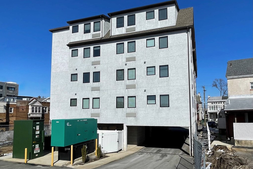 the front of a building with a parking garage
