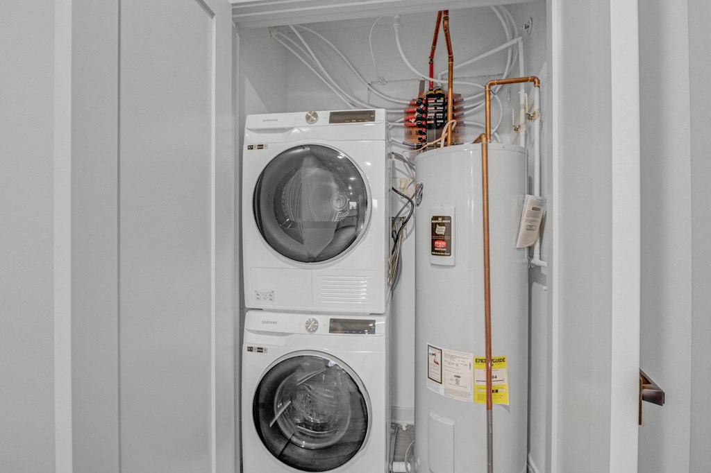a washer and dryer in a white utility room