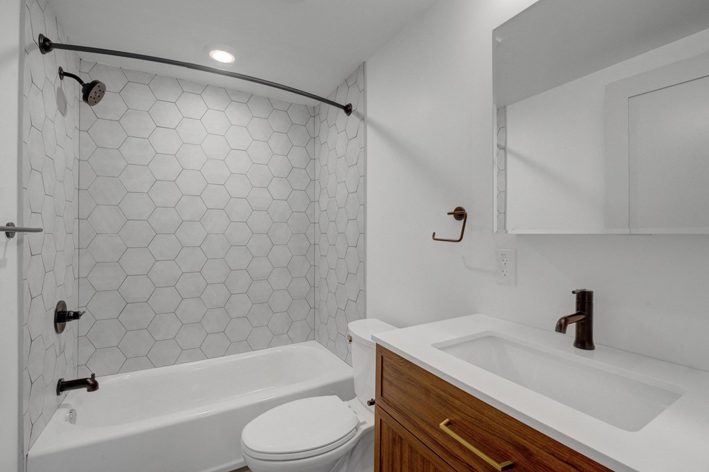 a bathroom with a sink toilet and a bath tub