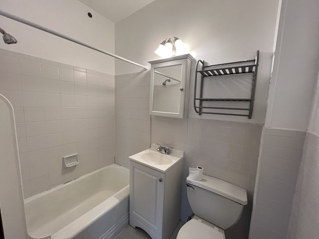 a bathroom with a sink toilet and a bath tub