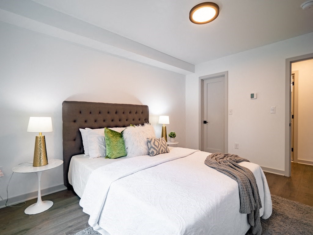 a bedroom with a large white bed and a white closet