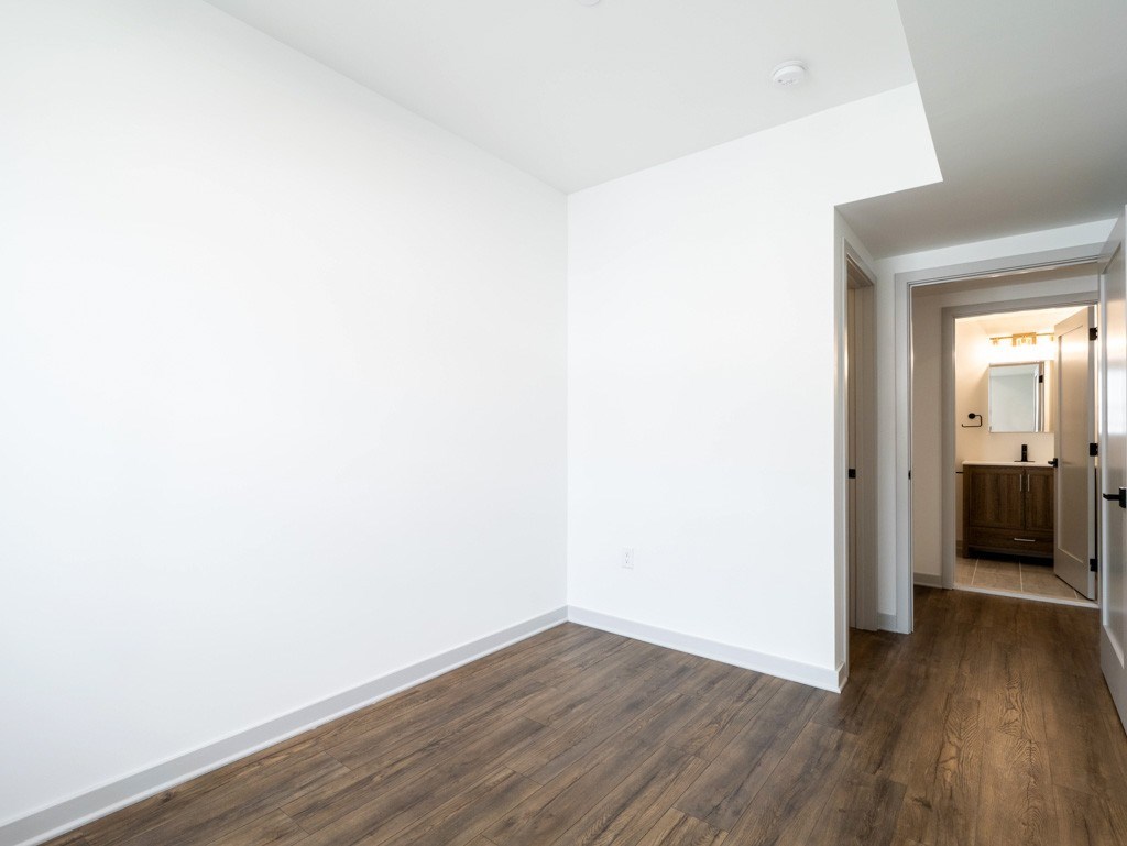 A room with white walls and wood flooring.
