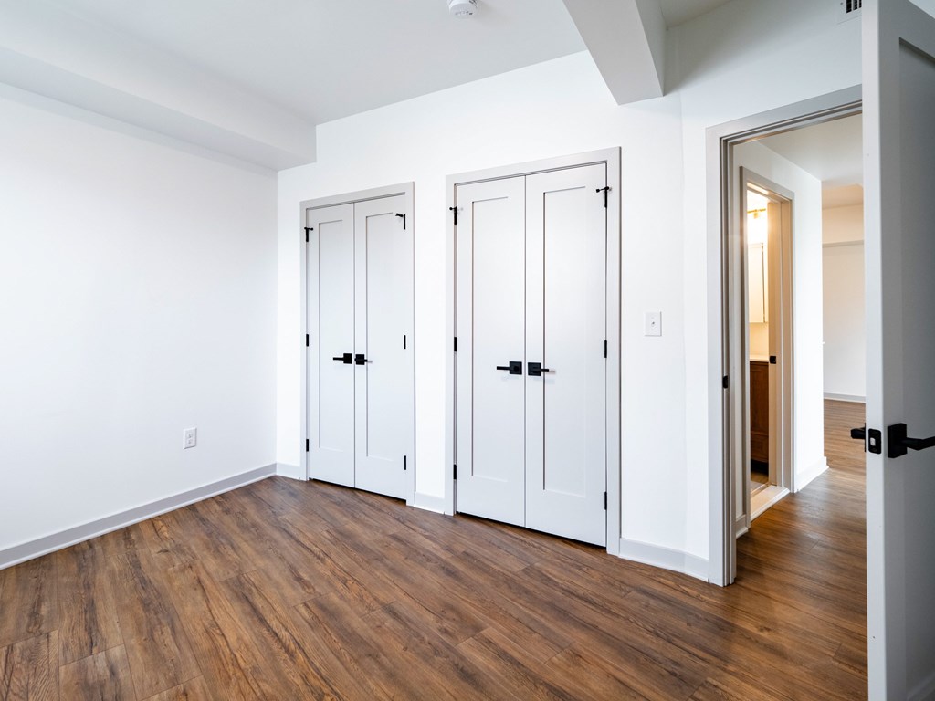 Three white doors are closed and one is open.