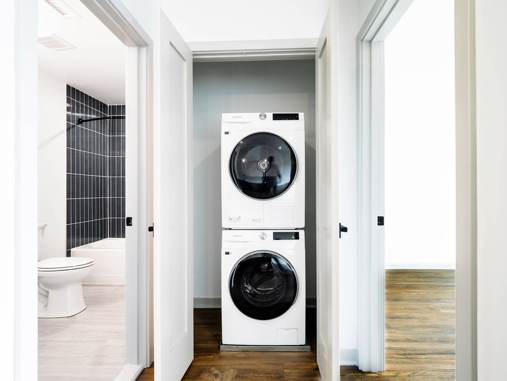A white washing machine and dryer in a laundry room.
