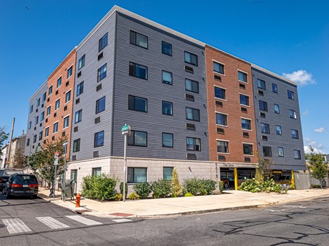 a large apartment building on the corner of a city street