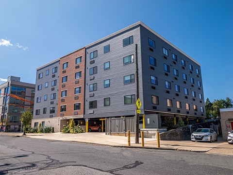 main view of the new building with parking lot and street