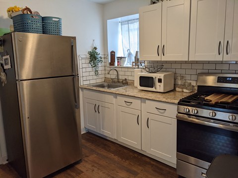 a kitchen with stainless steel appliances and white cabinets