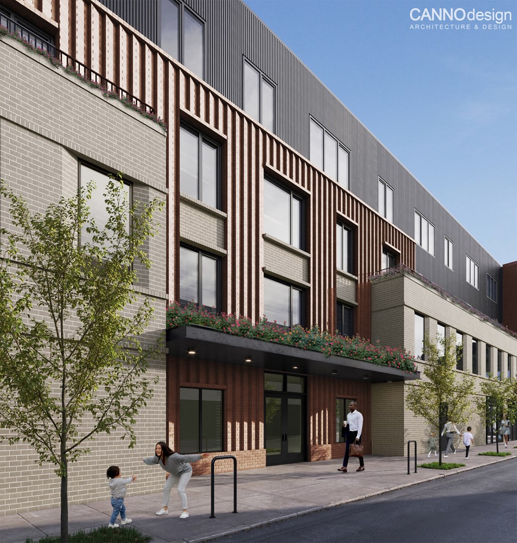 A modern building with a brick facade and balconies with plants.