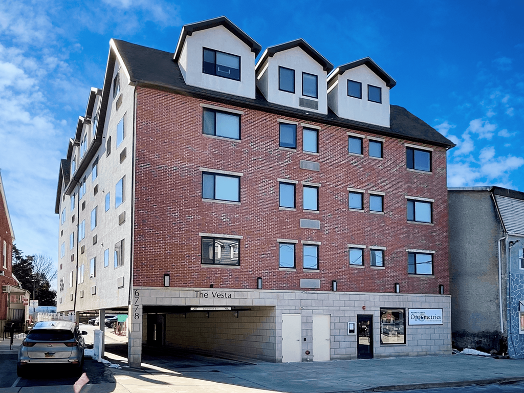a brick building with a car parked in front of it
