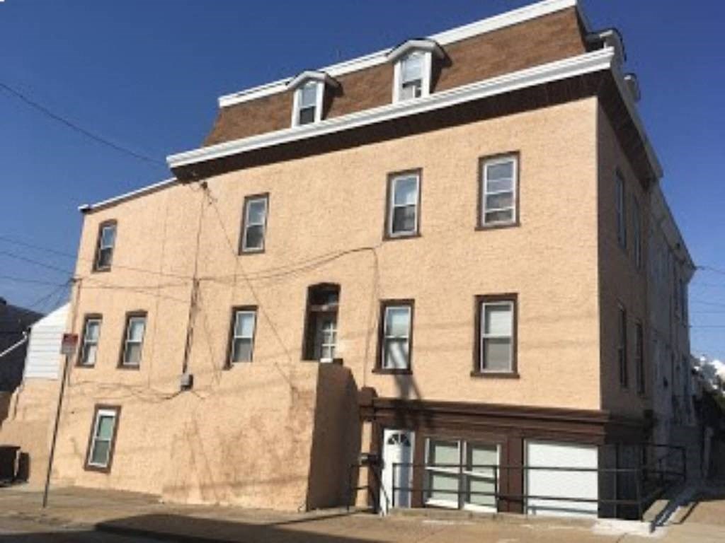 a large brick building with windows and a garage