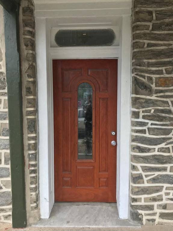 a red door in a stone building with a window