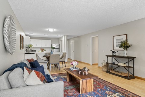 A living room with a grey couch and a coffee table.
