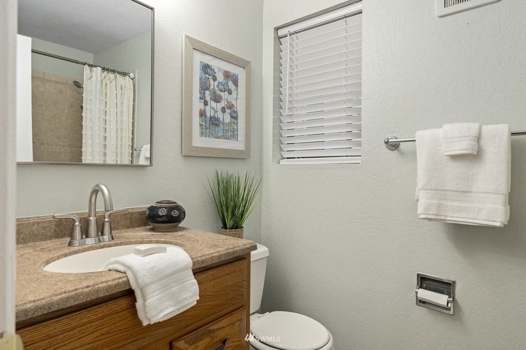 a bathroom with a sink and a mirror and a toilet