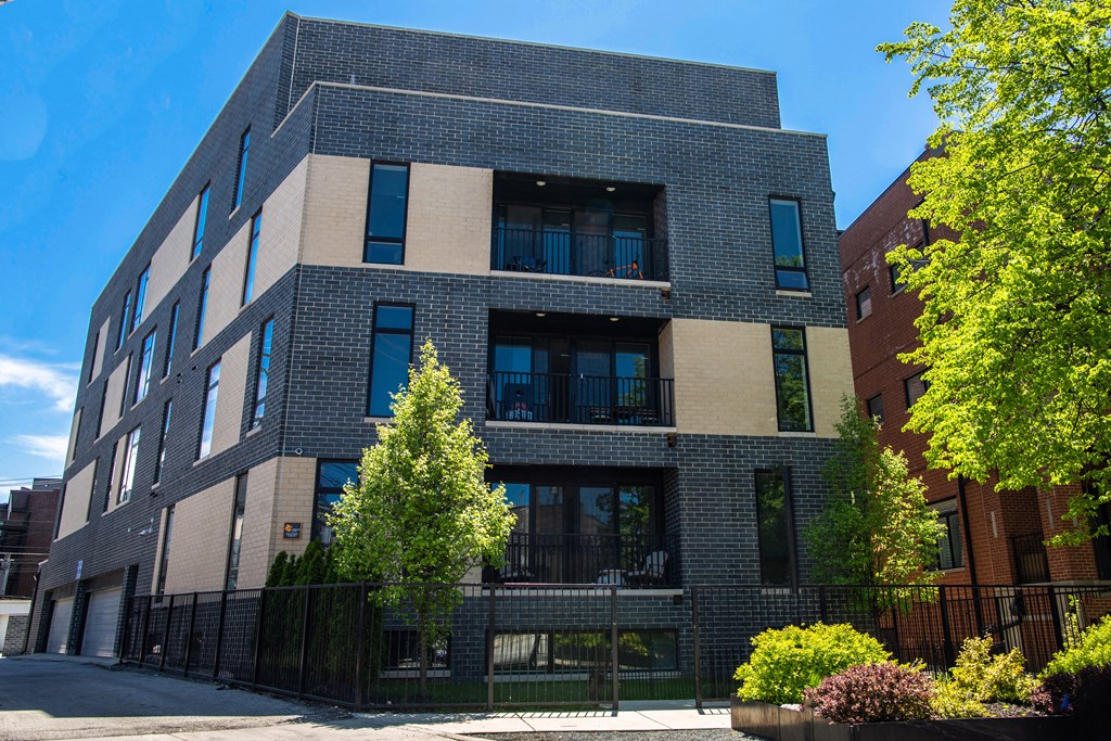 a large brick building with trees in front of it