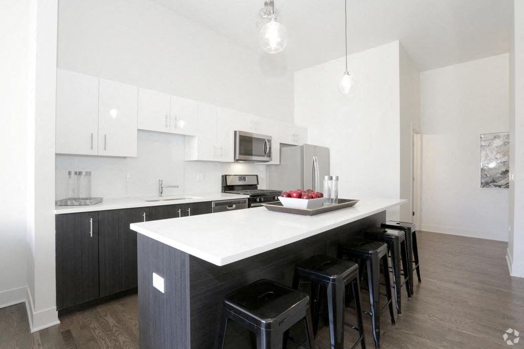 a kitchen with an island and bar stools