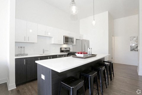 a kitchen with an island and bar stools