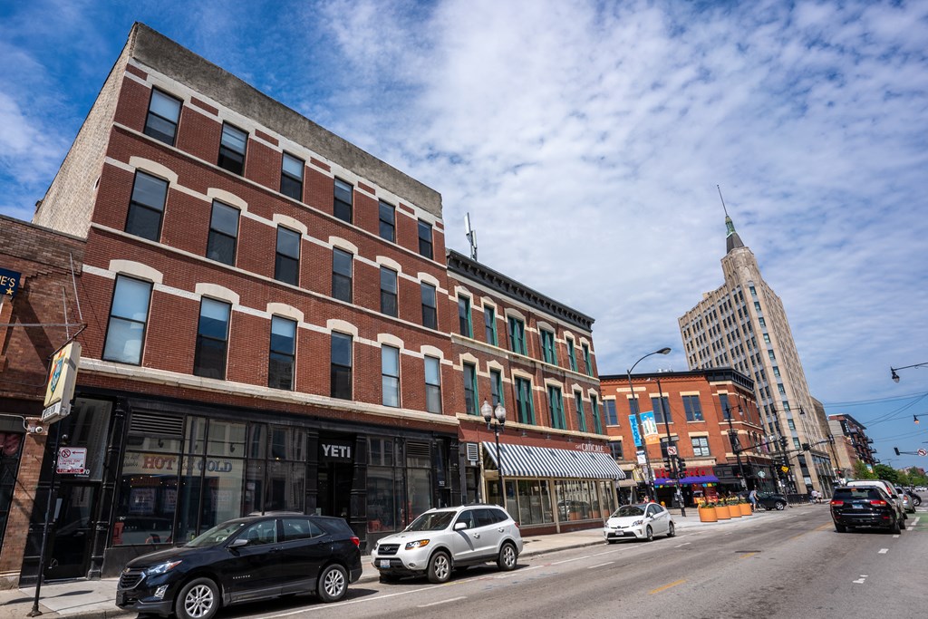 a view of a street in a city with buildings and cars